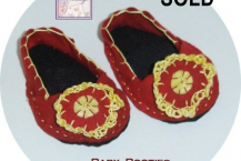 Red shoes with crocheted blossom